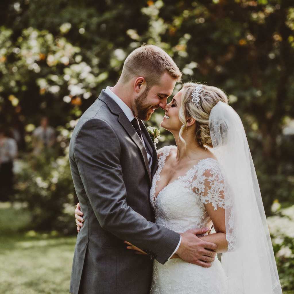 Intimate Moment Bride and Groom Share a Kiss on Their Wedding Day