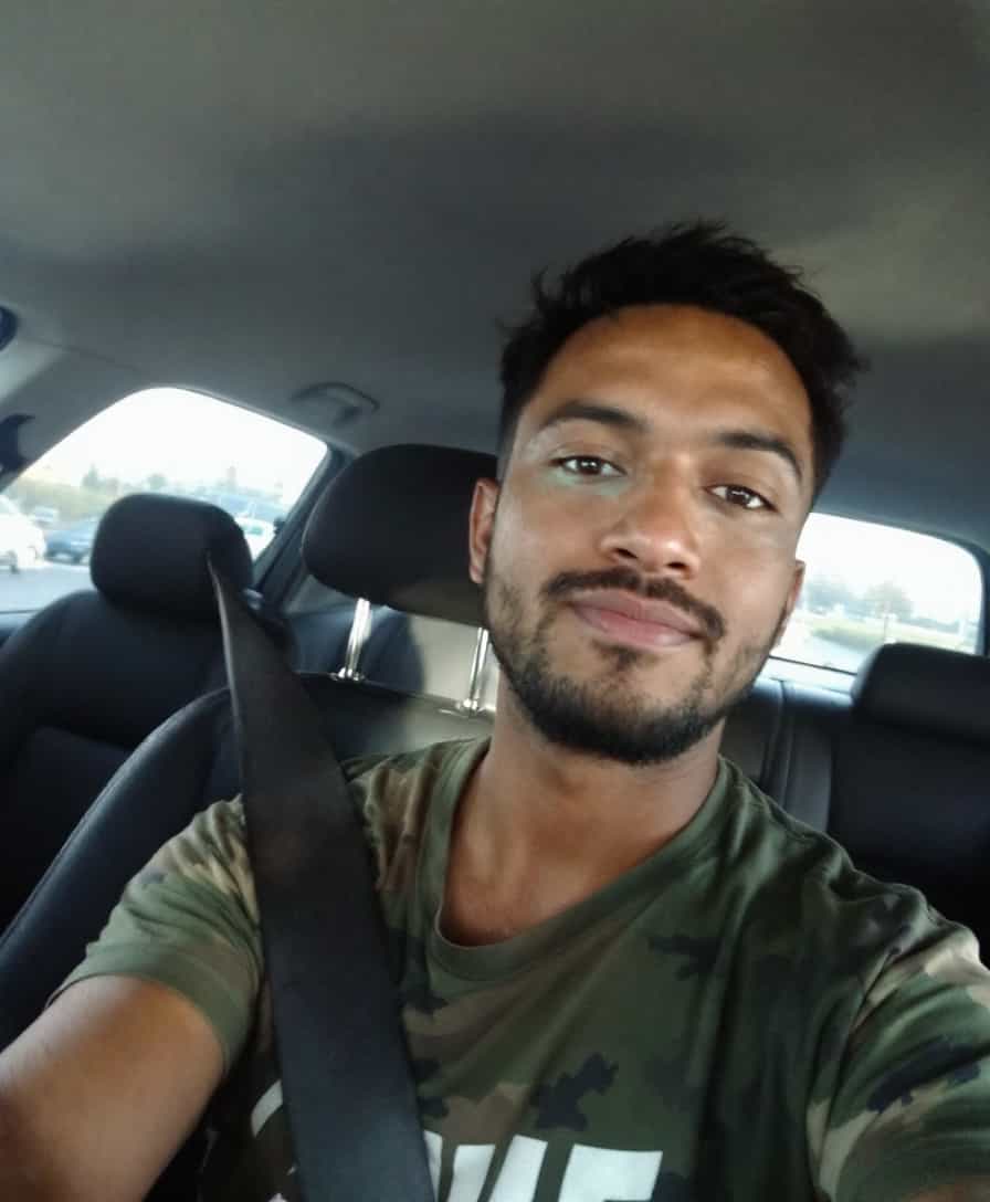 Man in Camo Shirt Taking Selfie in Car