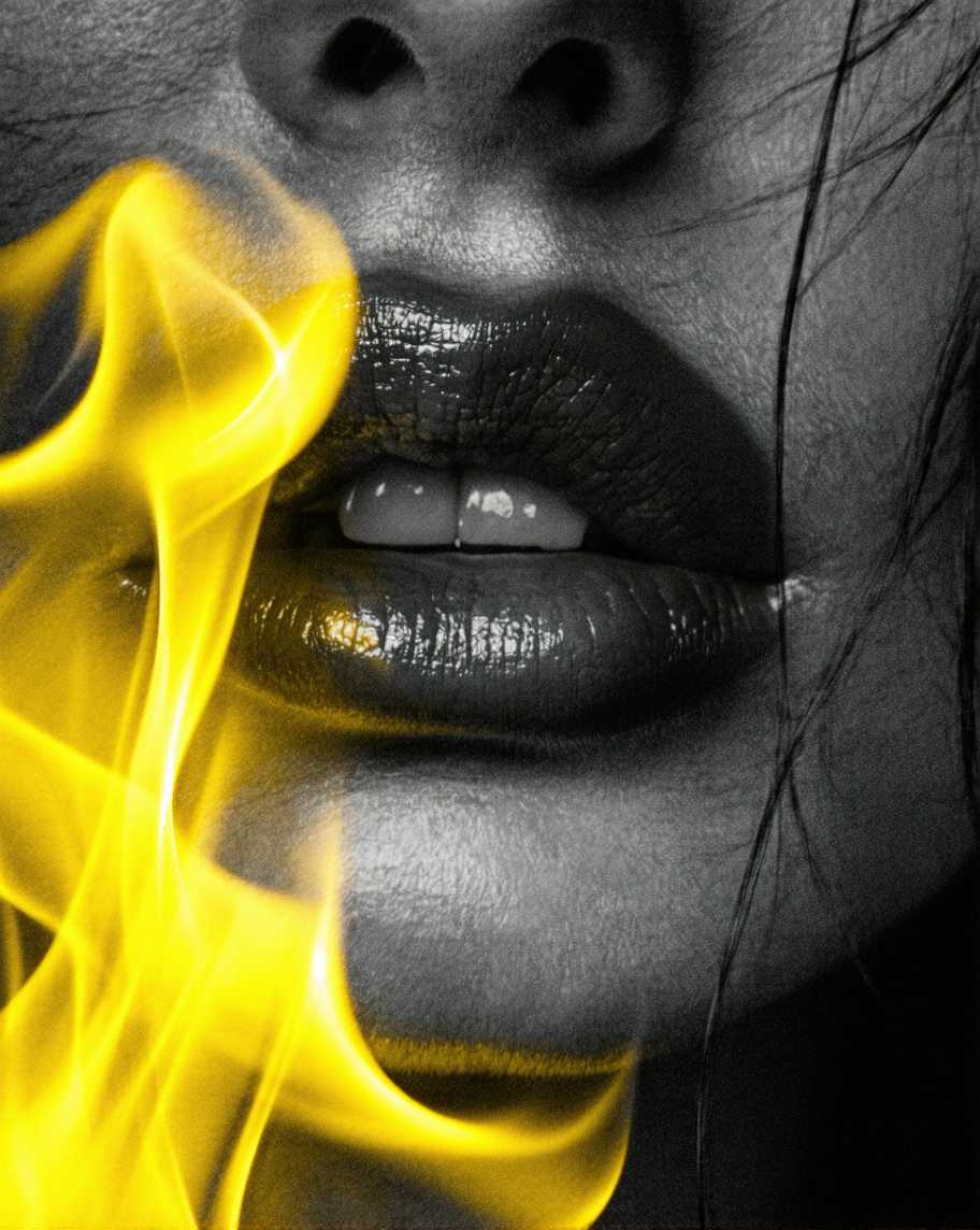Closeup of a womans lips with a fiery yellow smoke effect