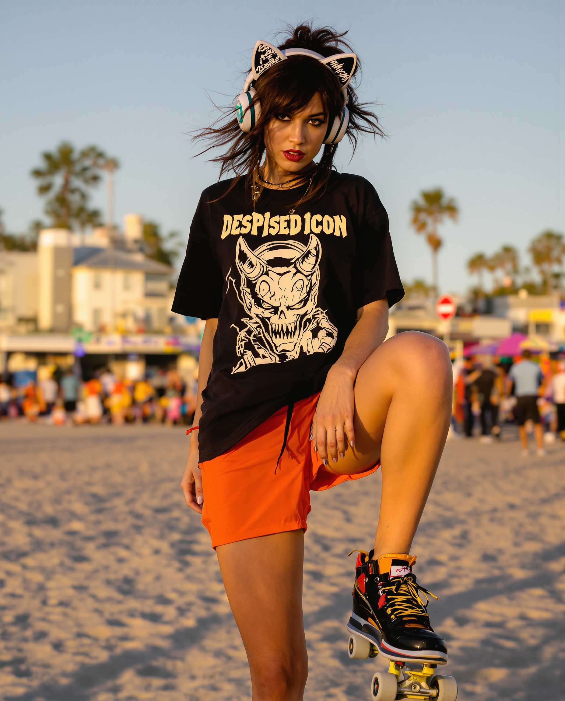 **Prompt:**

A dynamic full-body portrait of a young, punk-inspired woman in her late 20's, exuding a confident and rebellious vibe. She stands on razor skates at Venice Beach, California, at golden hour, where the setting sun casts a warm, vibrant glow on her skin and the surrounding environment. 

**Visual Details:**
- Her hair is a rich, untamed brunette, styled in a messy, yet stylish manner that complements her punk aesthetic. 
- She wears bright orange shorts, capturing the eye with their vivid hue against the beach's natural tones.
- Her black t-shirt features a bold graphic of a demon with the text "Despised Icon" in a grunge-inspired font, adding to her edgy look.
- Over her ears, she sports oversized headphones with whimsical cat ears, adding a playful yet ironic touch to her outfit.
- Her skin shows the subtle sheen of sweat, reflecting the light to highlight her athletic build.

**Style:**
- Capture this scene in a style reminiscent of modern street photography, focusing on candid moments with high contrast, and a slight graininess to convey the urban, raw energy of Venice Beach.

**Composition:**
- The woman is captured in a dynamic pose, with one leg bent, showcasing her skill on the razor skates, her body slightly turned to the side, but her gaze directly engaging the viewer, creating a sense of interaction.
- The camera angle is slightly low to emphasize her height and the freedom of movement, with a shallow depth of field to blur the bustling background of the beach.

**Mood and Atmosphere:**
- The atmosphere is lively and energetic, with the beach's crowd in the background, creating a contrast between her personal space and the vibrant public setting. 
- The time of day is just before sunset, enhancing the mood with a golden, almost ethereal light that softens the scene.

**Technical Aspects:**
- Utilize a fast shutter speed to freeze her motion, ensuring clarity in her pose against the backdrop of a busy, moving environment.
- Employ a wide aperture for a shallow depth of field, focusing sharply on her while allowing the background to blur, emphasizing her as the central figure.

**Cohesion:**
- All elements should work in harmony to create a believable scene at Venice Beach, where the punk aesthetic meets the carefree spirit of beach culture, resulting in a unique, visually compelling image.