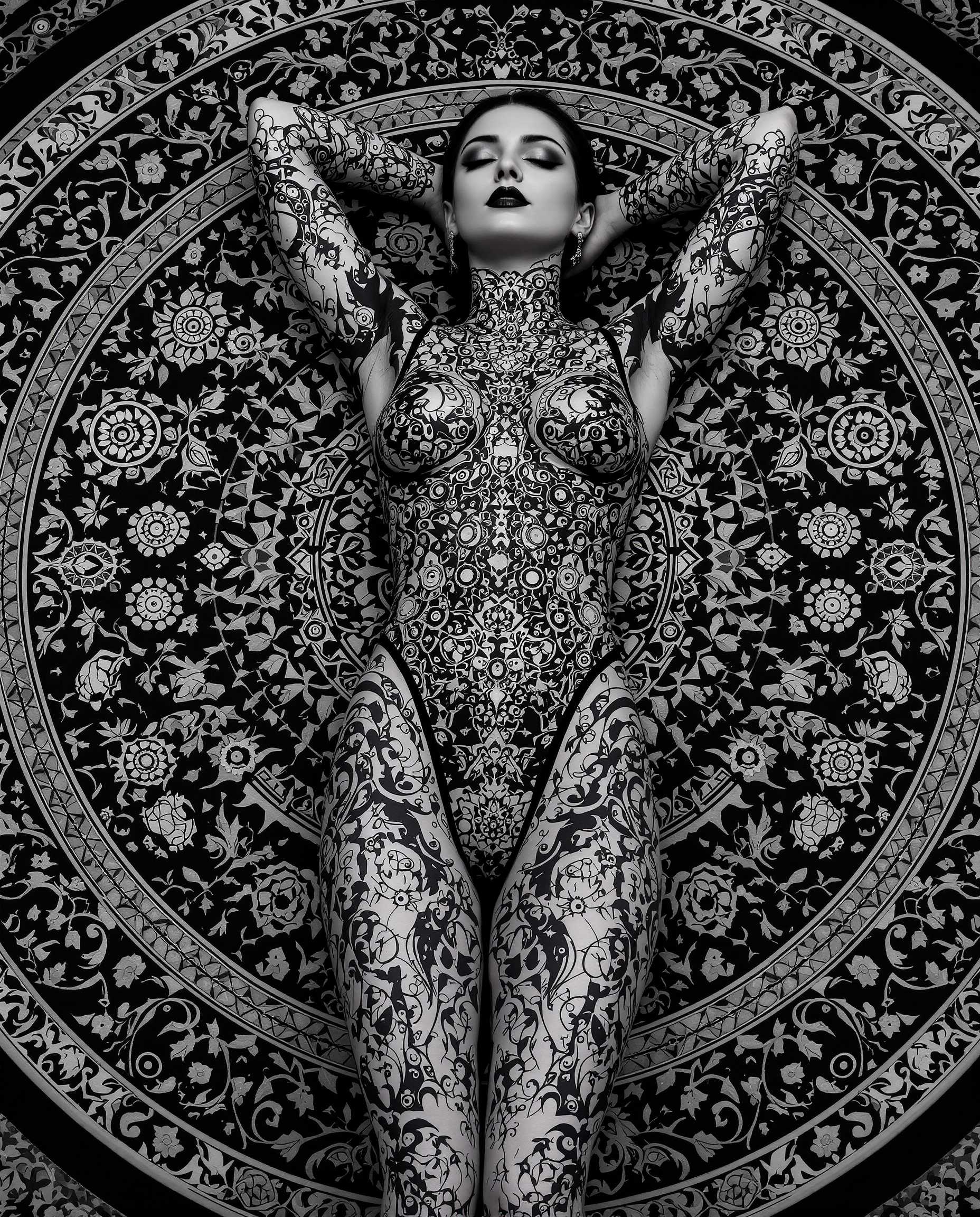 This is a realistic photo (photograph) of a female real person highly stylized and detailed digital artwork, predominantly in grayscale with a few highlights of black and white. The subject of the artwork is a figure lying on their back, with their arms resting behind their head, conveying a relaxed or contemplative pose.The figure is adorned with intricate, gothic inspired tattoos that cover their entire body. The tattoos are elaborate, with a repetitive pattern of circular motifs, floral designs, and what appear to be mechanical elements, such as gears and cogs. The tattoos are executed with precision, and the shading and highlights give them a threedimensional quality.The figure is wearing a formfitting bodysuit that complements the tattoos, with a similar gothic design. The bodysuit is made of a shiny, possibly metallic material, which reflects the light and adds to the threedimensional effect of the artwork.The figure is lying on a circular, ornate carpet or mat that has a complex, symmetrical pattern. The pattern is reminiscent of Islamic or Ottoman style tile work, with interlocking geometric shapes and floral motifs. The carpets design is monochromatic, with shades of black and white, and it provides a stark contrast to the figures tattoos and the shiny texture of the bodysuit.The overall art style of the image is realistic, with a focus on detailed line work and shading that gives the characters and objects a lifelike quality. The medium appears to be digital painting, given the smooth gradients and seamless blending of colors.The colors in the image are primarily shades of gray, with black and white accents. The grayscale palette gives the artwork a moody and atmospheric quality, while the highlights of black and white add depth and contrast.Overall, the image is a striking and visually compelling piece of digital art that combines gothic aesthetics with intricate design and shading techniques.
