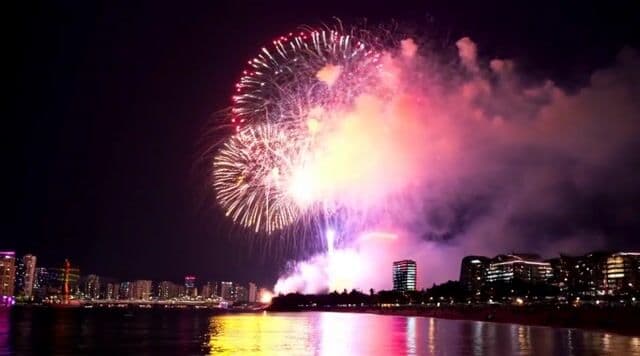 Amazing massive Firework over ocean side city skyline. 