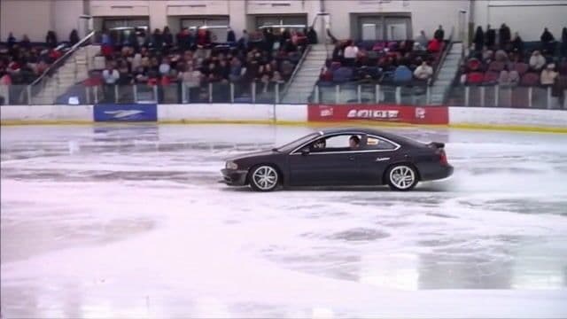 a car drifting around an ice rink
