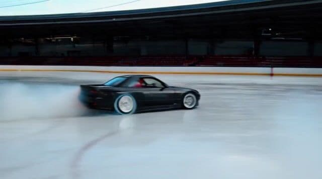 a car drifting around an ice rink