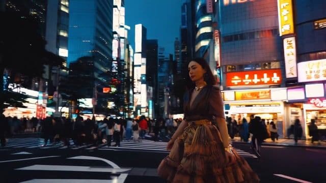 A woman walking through the streets of tokyo