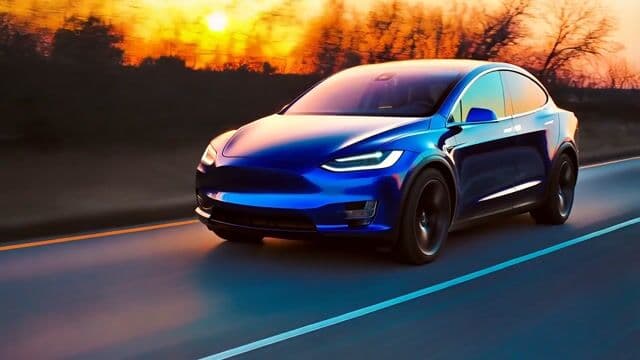 A tesla model X speeding down the highway