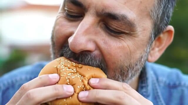 A man eating a cheeseburger