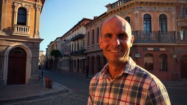 a man walks down the street in Lisbon