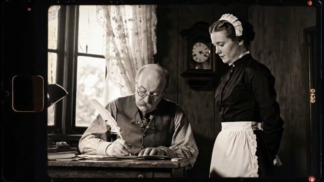 {
  "shot": {
    "composition": "Medium shot, 35mm lens, shot on vintage hand-cranked camera, square 4:3 aspect ratio",
    "camera_motion": "static camera",
    "frame_rate": "16fps",
    "film_grain": "heavy monochrome film grain with flicker and frame jitter"
  },
  "subject": {
    "description": "An old man with a balding head, round spectacles, and a thick mustache, dressed in a worn waistcoat and rolled-up shirt sleeves, seated at a wooden desk cluttered with ink pots, letters, and a candle",
    "wardrobe": "faded striped shirt, grey waistcoat with brass buttons, wire-rimmed glasses perched on nose",
    "secondary_character": "A young maid standing beside him, wearing a classic Victorian maid's uniform with a white apron over a long black dress, and a lace cap framing her tightly pinned hair"
  },
  "scene": {
    "location": "dimly lit Edwardian-era office",
    "time_of_day": "afternoon",
    "environment": "dark wood-paneled room, dusty windows with sheer curtains, a tall bookcase in the background, and a ticking wall clock slightly out of focus"
  },
  "visual_details": {
    "action": "The old man writes attentively with a quill pen, head slightly hunched, never pausing or acknowledging the presence beside him. The maid stands respectfully at his side, hands gently clasped. She leans forward slightly and softly speaks to him, her delivery calm and confident, in a well-trained domestic tone."
  },
  "cinematography": {
    "lighting": "natural light filtered through lace curtains, casting textured shadows across the room; high contrast between lit face and darkened surroundings",
    "tone": "nostalgic, contemplative, observational"
  },
  "audio": {
    "ambient": "the quiet scratching of quill on paper, faint ticking of a mechanical clock, subtle wood creaks",
    "dialogue": {
      "character": "Maid",
      "line": "Sir, would you like a cup of tea and cake?",
      "voice_tone": "clear, soft-spoken, slightly formal",
      "accent": "strong British accent",
      "rhythm": "gently rising with crisp diction, measured pace typical of trained domestic service",
      "frequency": "contralto range, low and composed"
    }
  },
  "color_palette": "black and white with period-accurate flicker, light sepia tint around edges to simulate aged celluloid",
  "dialogue": {
    "character": "Maid",
    "line": "Sir, would you like a cup of tea and cake?",
    "subtitles": false
  }
}