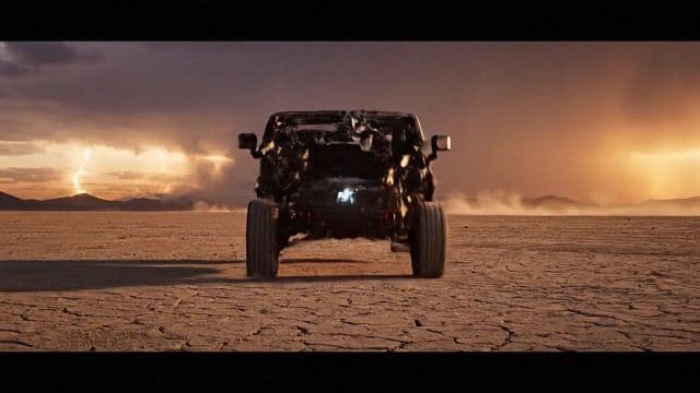 === Shot ===

Composition: central low-angle wide, Hummer forming mid-air piece by piece
Lens: 24mm
Frame Rate: 2000fps for impact, 60fps camera motion
Camera Movement: ground tracking, orbital spin, vertical rise

=== Subject ===

Description: Hummer EV, chassis, tires, shell, grille assembling in slow explosive layers
Wardrobe: 
Props: armor plating, LED bar, mud-crushing tires, electric core pulse

=== Scene ===

Location: dry cracked desert basin
Time Of Day: sunset storm
Environment: dust, wind trails, light flares, far-off thunder glow

=== Visual Details ===

Action: parts crash in with dust shock, body seals, wheels spin and slam down, final headlight flare and dust burst
Special Effects: slow debris, flare ignition, kinetic ripples, vapor trails
Hair Clothing Motion: 

=== Cinematography ===

Lighting: sunset rimlight + tactical highlights
Color Palette: matte sand, obsidian black, steel grey
Tone: premium, off-road dominance

=== Audio ===

Music: deep hybrid trailer score, rising tension then impact
Ambient: wind, echoing terrain hum
Sound Effects: metal snaps, suspension drop, dust whoosh, electric pulse
Mix Level: studio-grade mix, wide stereo field, punchy dynamics

=== Dialogue ===

Character: 
Line: 
Subtitles: false