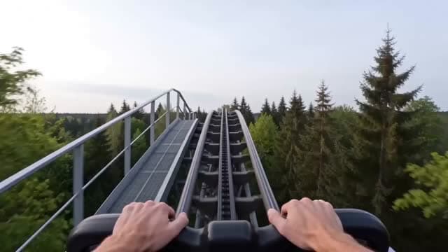 first-person roller coaster, one continuous shot, natural scene transitions.