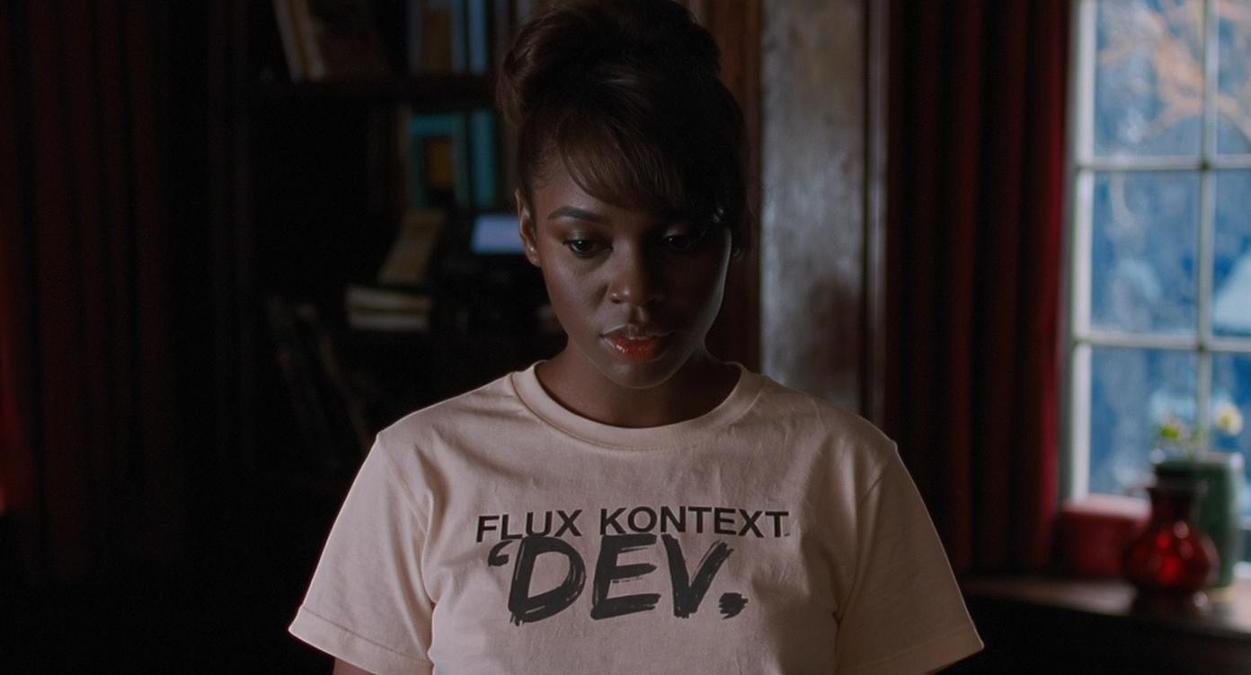 An image of a woman wearing a shirt that says FLUX KONTEXT DEV