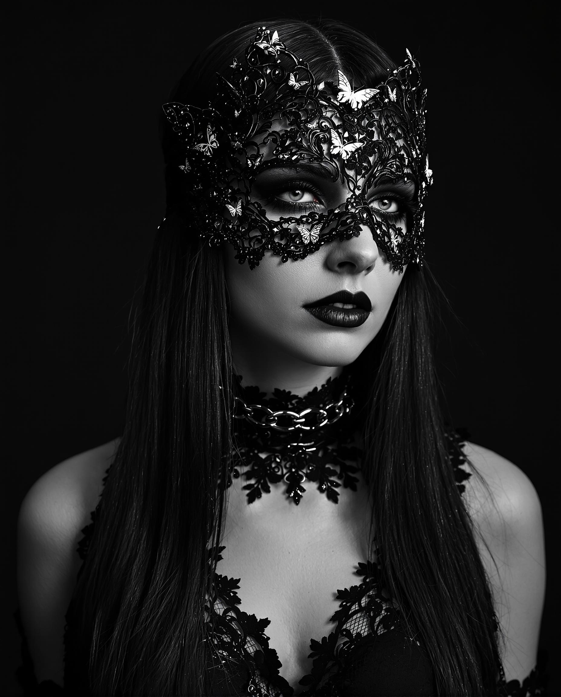 A striking monochromatic photograph of a female figure, captured in a gothic fantasy style with a black-and-white color scheme, emphasizing intricate line work and fine detailing. The subject has long, straight hair cascading down the frame, textured with delicate lacelike patterns, and wears a gothic choker with a chained collar of matching lace design, alongside a black lace blindfold adorned with ethereal butterflies symbolizing transformation. Set against a dark, nondescript background, the image exudes mystery and elegance with cinematic lighting and 8K detail.