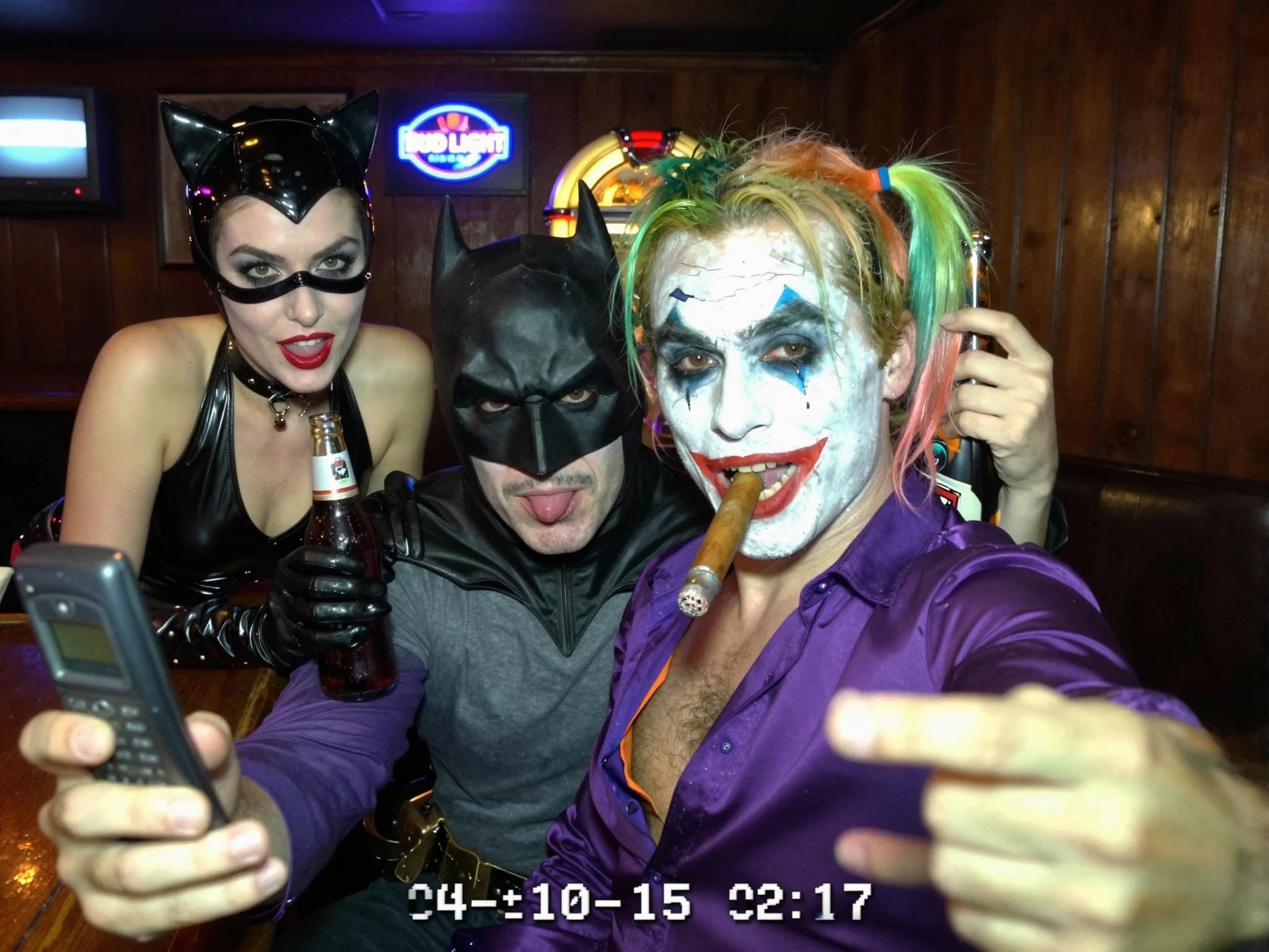 {
 2004 VGA bar-selfie: Joker (smudged white greasepaint, green-tinted slicked hair, purple satin shirt open to chest, lit cigar) holds flip-phone at arm’s length, wide-angle lens slightly tilted. Batman (black cowl, matte finish, visible jaw stubble, grey T-shirt) sits centre, eyes narrowed at lens, one brow raised. Catwoman (black PVC halter, cat-ear headband, smudged eyeliner, red lipstick) leans over bar, gloved hand on Joker’s shoulder. Harley Quinn (red/blue crop top, diamond face paint cracked, pigtails with faded ribbon) pops between them, tongue out, holding a half-empty beer bottle. Background: dim wood-paneled dive bar, Bud Light neon blur, CRT TV static, jukebox glow. Harsh on-camera flash blows highlights, green-yellow white-balance shift, heavy VGA noise, 640×480 pixel stretch, date-stamp ‘04-10-15 02:17’. Mild motion blur on Harley’s bottle, dust specks on lens, finger partially covers corner. --ar 4:5 --style raw",
  "style": "photographic 2004 VGA analog selfie",
  "negative_prompt": "logos, text, extra limbs, smooth skin, HDR, modern phone",
  "output": {
    "format": "jpg",
    "long_edge_px": 1536
  }
}