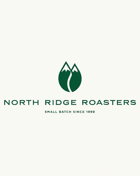 A logo with a green coffee bean shaped like two snowy peaks above the wordmark NORTH RIDGE ROASTERS