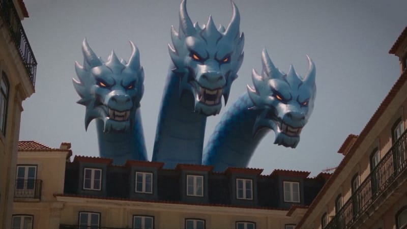 The three-headed inflatable dragon rising over sunny city rooftops