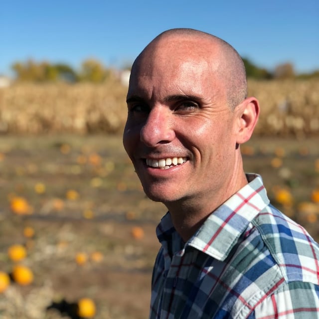 Brian smiling in a sunny pumpkin field, the kind of everyday photo you upload to train a LoRA