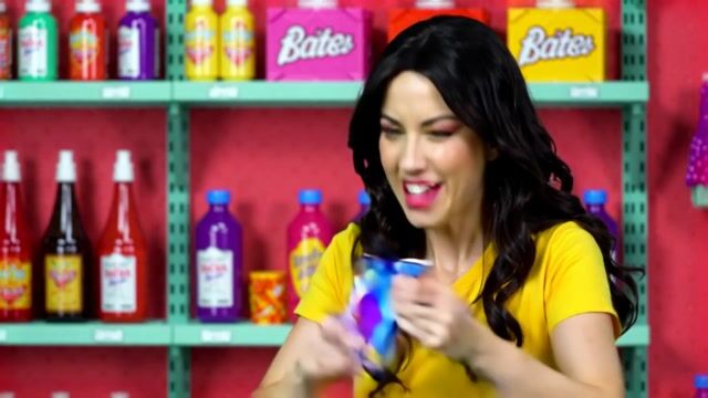 A realistic scene of a woman in a candy store frantically searching to find the last pixel dojo candy bar. once she finds it she exclaims, "gotta have that pixel dojo candy". the candy features a pixelated purple dragon with the text "pixel dojo" on the wrapper.