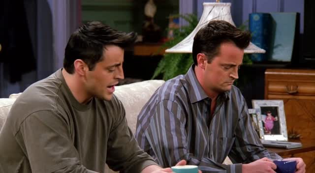 Joey and Chandler sit side by side on the couch with coffee cups. Joey turns to Chandler with a completely sincere, concerned expression.

DIALOGUE:

JOEY: “Could AI replace us?”

Chandler slowly looks up from his coffee. Pauses. Looks Joey dead in the eye.

CHANDLER: “Joey, AI cannot replace you. Nothing can replace you. Well, except Pixel Dojo.”

Joey nods slowly. Visibly relieved. Processing.

JOEY: “Because It's too good?”

Chandler stares at him. Long beat. He looks down at his coffee, then back up.

CHANDLER: “…That's right. It just is.”

STYLE: Warm 90s sitcom aesthetic, steady handheld feel, natural performances, characters in casual clothing. Joey played completely straight — zero irony. Chandler delivers every line with exhausted deadpan sarcasm. Hold on Chandler’s face after the final line for a full beat before cut.”