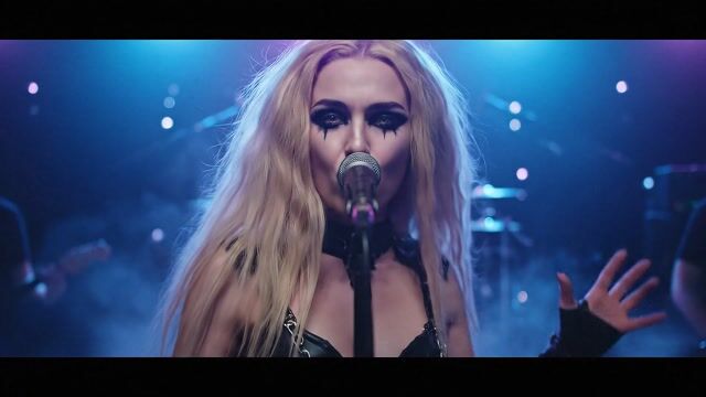 AI-generated image: {
  "subject": "a young female gothic rock singer with very long wild blonde hair, wearing a leather