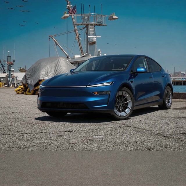 AI-generated image: {
  "shot_composition": "A rear three-quarter view of a sleek deep blue Tesla Model Y electric cross