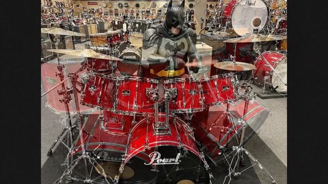 AI-generated image: Batman,plays the drums at a music store in a "Jazz Fusion" style.