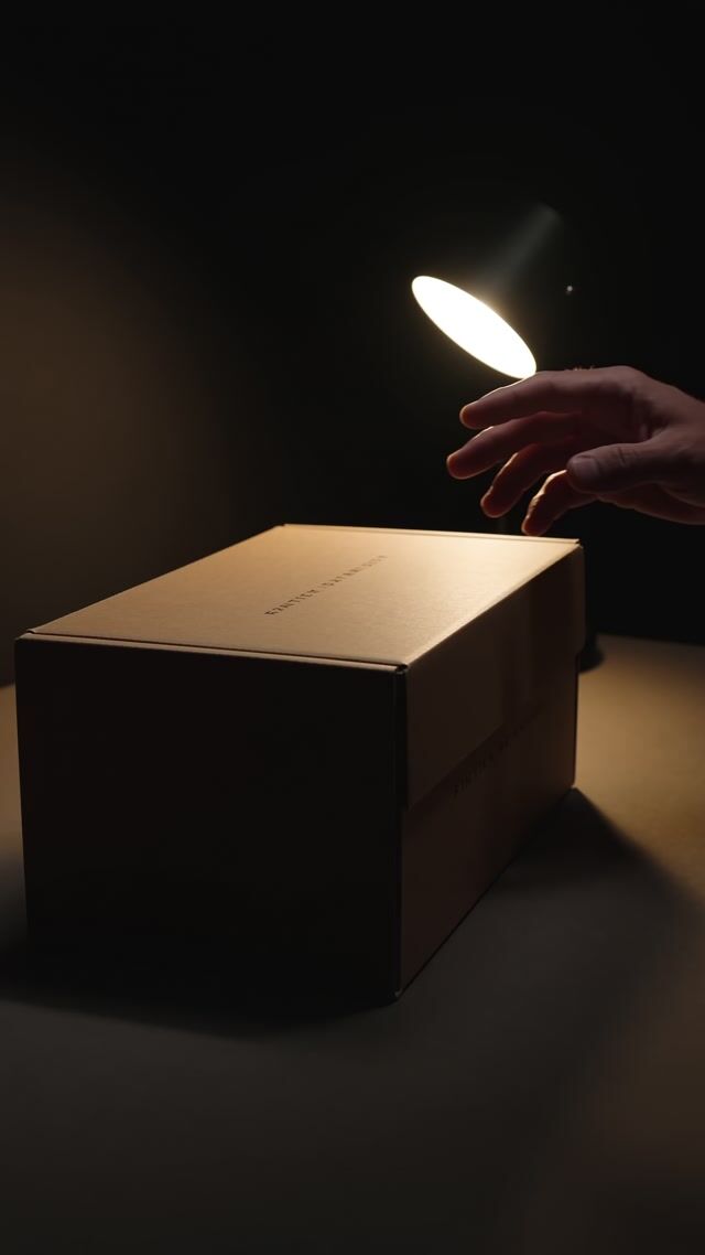 Reaching Hand Over Mystery Box