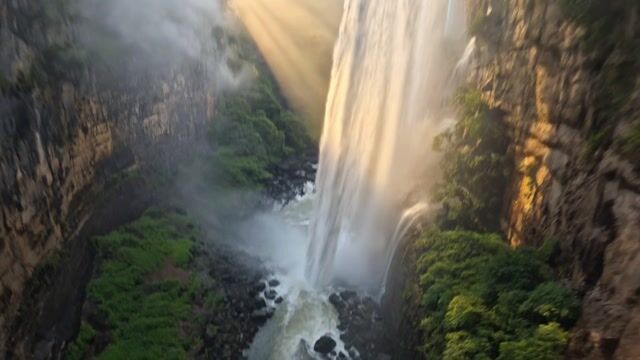 Sunrise Shafts Over the Plunge