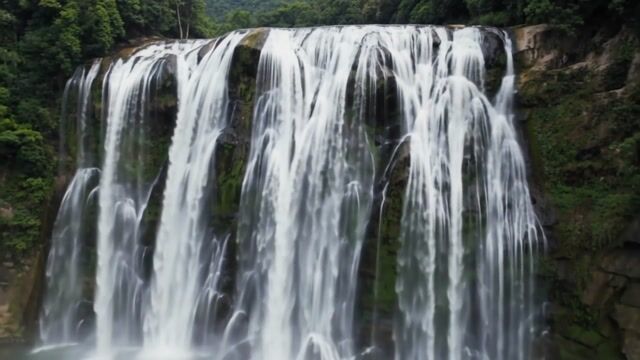 Verdant Cascade Over Mossy Cliffs