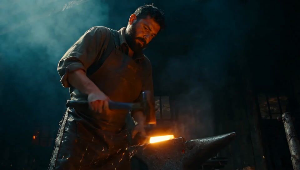 Low angle shot of a bearded blacksmith in a leather apron striking a glowing orange steel bar on an anvil, sparks flying through blue smoke in a dark forge