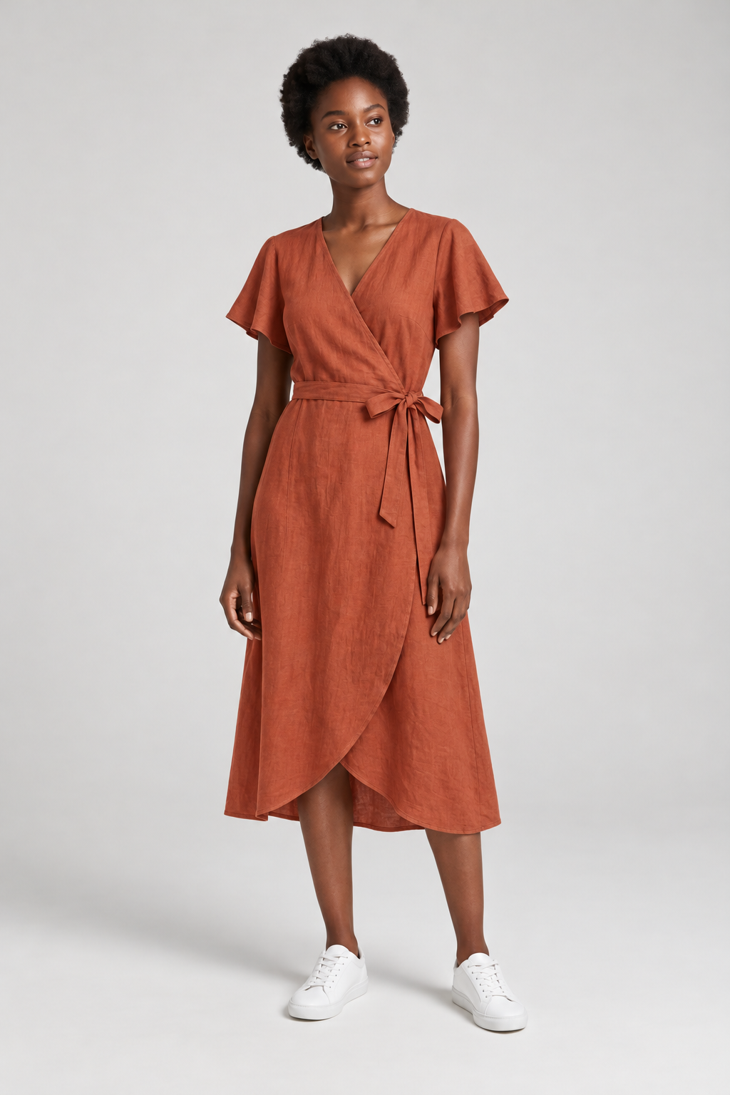 GPT Image 2.5 try-on: the same model wearing the rust wrap dress, full length on the grey backdrop