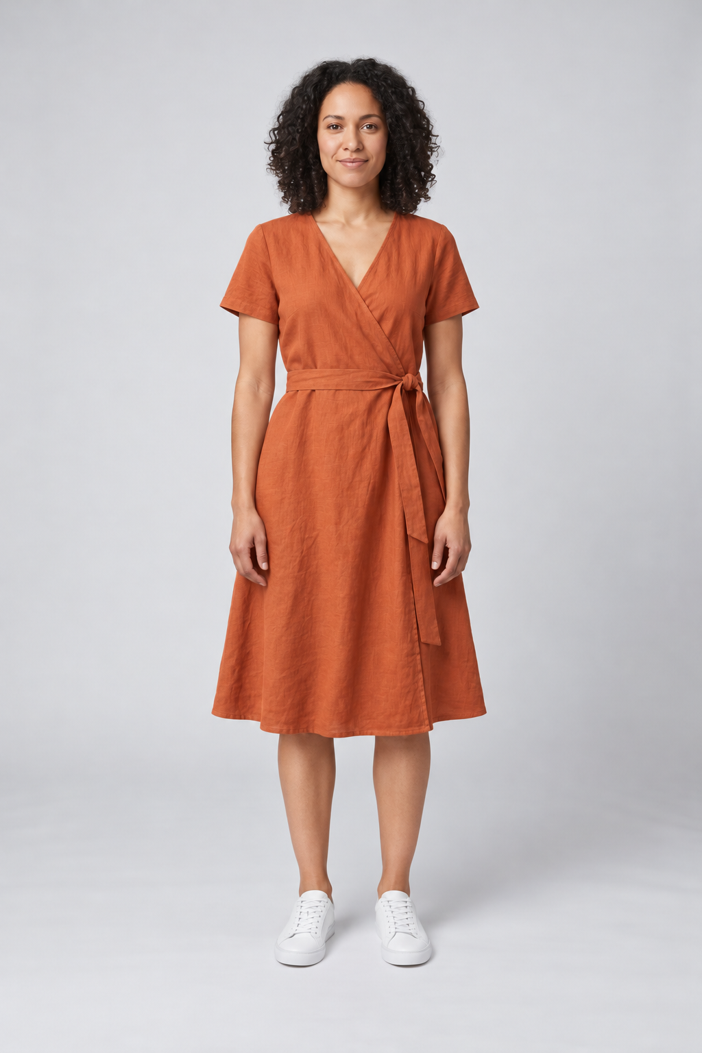 GPT Image 2.5: the woman in the rust wrap dress with a soft, longer linen drape below the knee