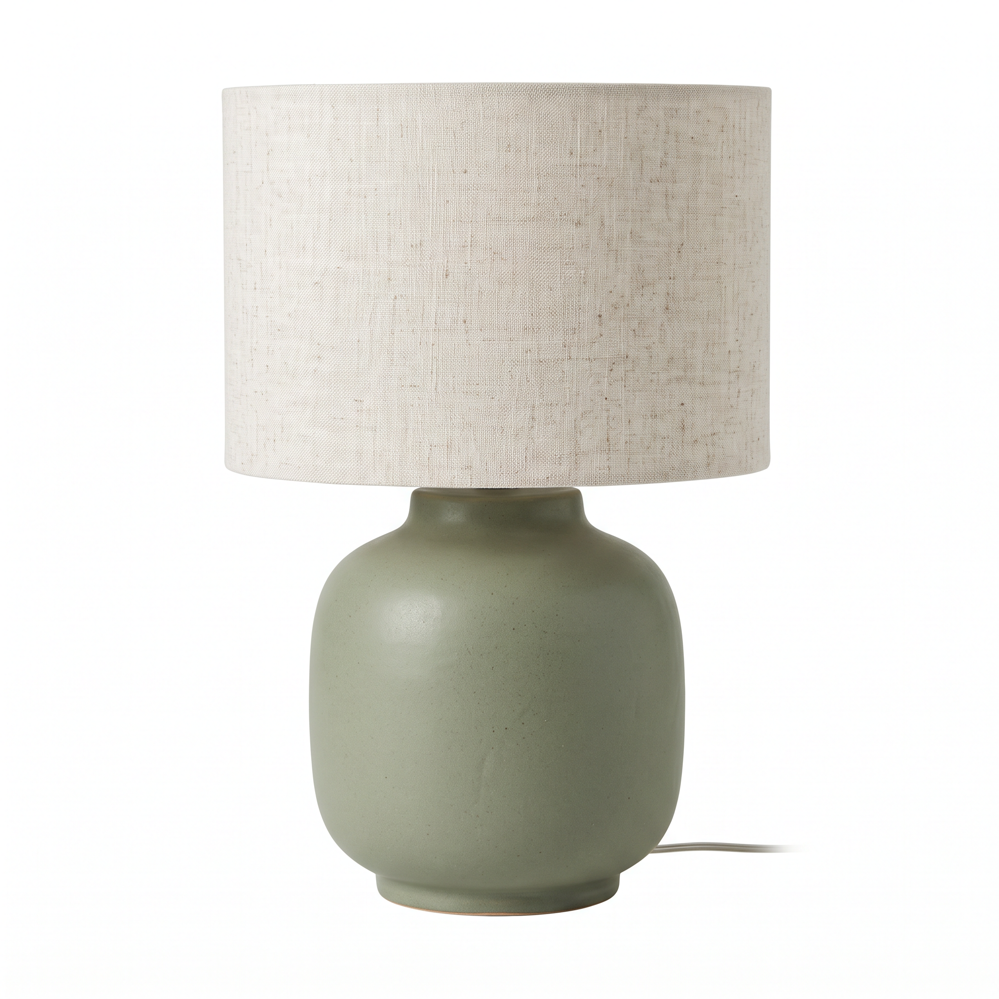 The packshot: a matte sage green ceramic lamp with a natural linen shade on pure white