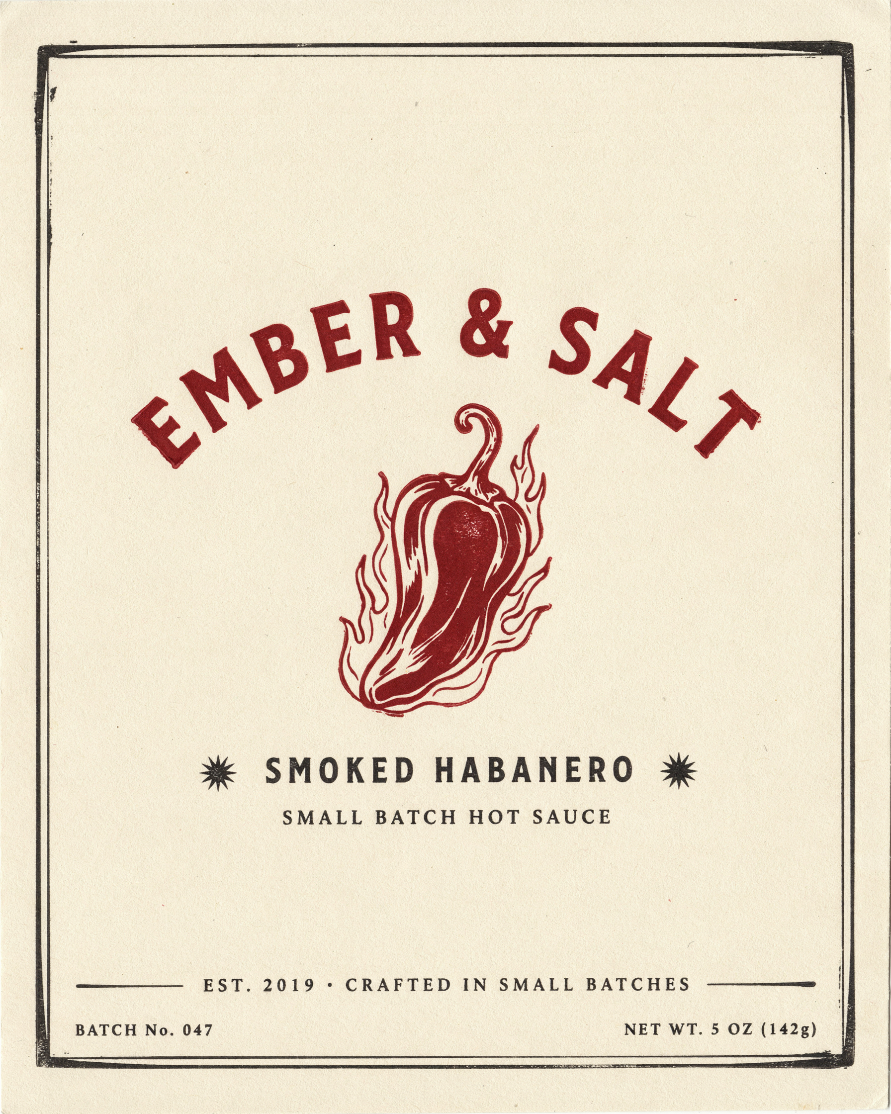 A cream and red letterpress hot sauce label reading EMBER & SALT, SMOKED HABANERO