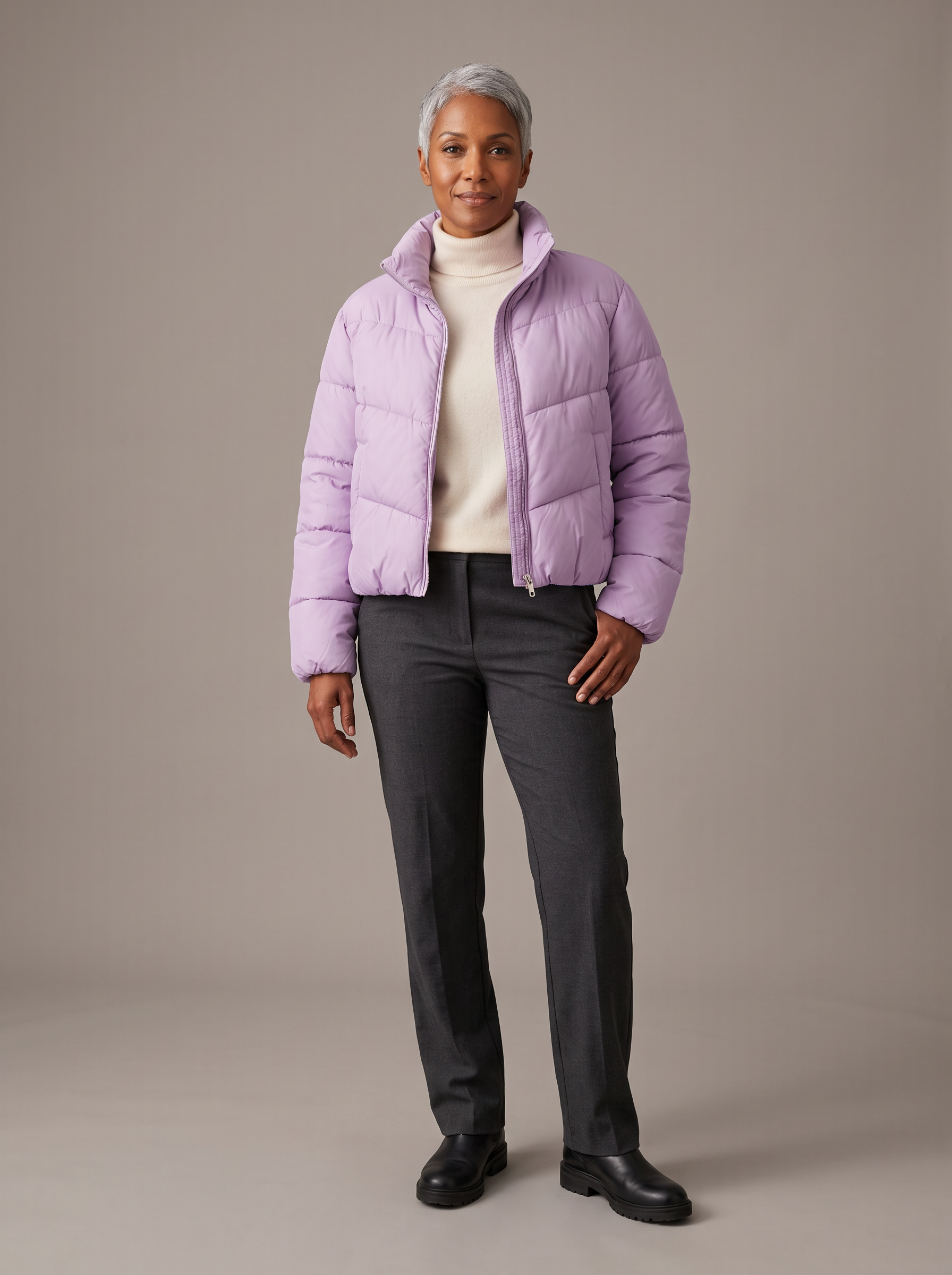 Step 2, Nano Banana 2.1: a woman in her forties with a silver pixie cut wears the jacket over a cream turtleneck on a grey studio backdrop